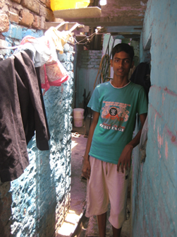 Senthil in the narrow lane outside his house