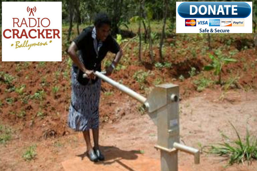 African woman pumping clean water at a well
